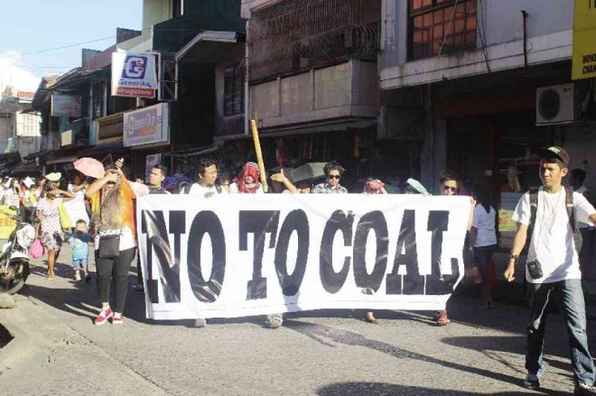 PROTESTERS, led by Church leaders, march in protest of a planned coal power plant in Atimonan town, the third coal power plant that the province of Quezon would host should it push through.CONTRIBUTED PHOTO 