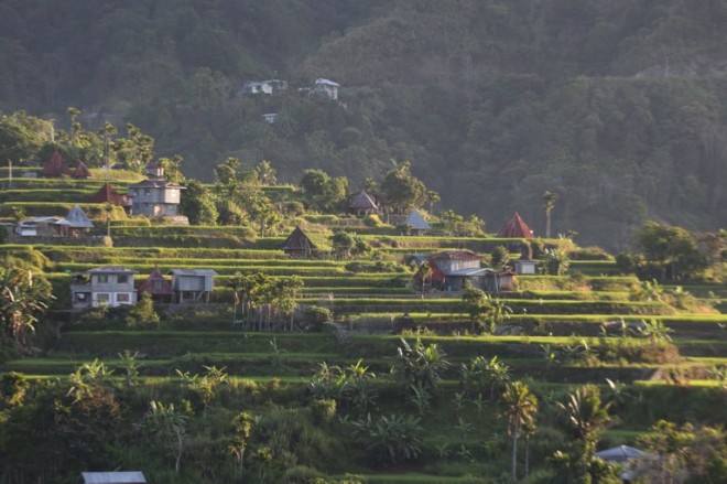 This photo taken on April 28, 2015, shows houses sitting amid rice terraces on a mountainside in Mayoyao, Ifugao province, part of the spectacular region in the northern Philippines that is listed by Unesco as a World Heritage site. The region is famed for its beauty, a vibrant tribal culture and ingenious farming techniques invented 2,000 years ago. But it is all under threat as the powerful forces of modernity start to penetrate. AFP PHOTO/KARL MALAKUNA