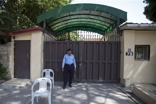 A Pakistani police officer stands guard outside a sealed 'Save the Children' office in Islamabad, Pakistan, Friday, June 12, 2015. The Pakistani government shut down the offices of the international aid group for violating its charter, the country’s interior minister and officials said Friday. AP Photo