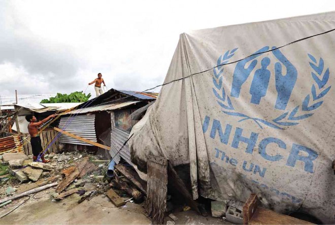 SHELTERS, like this tent with a UNHCR marking, dotted the landscape of Tacloban City following the onslaught of Supertyphoon ‘Yolanda’ in November 2013. The completion of permanent homes for residents who lost theirs to Yolanda has been slow, prompting city officials to appeal for a faster construction pace. RAFFY LERMA 