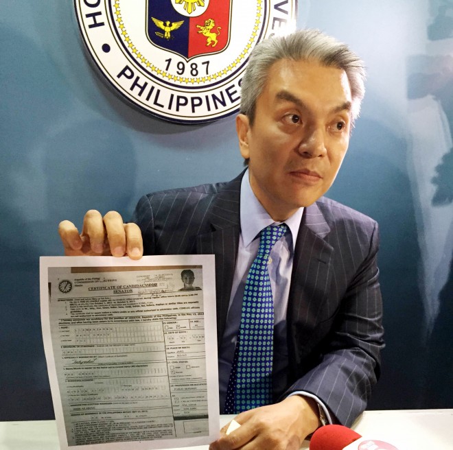 Tiangco shows Senator Grace Poe's certificate of candidacy showing she is not qualified to run as president or vice president next year. Marc Jayson Cayabyab/INQUIRER.net