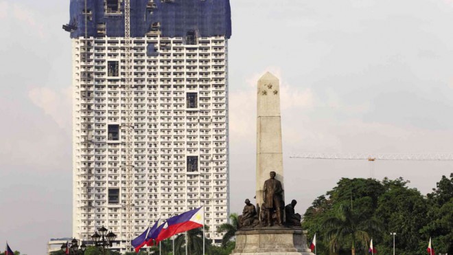 Towering over Rizal Monument at Rizal Park, the controversial 46-story Torre de Manila, described by opponents as an eyesore around the skyline of a heritage site, is almost complete. On Tuesday, the Supreme Court finally acted, issuing a temporary restraining order on its construction.  MARIANNE BERMUDEZ