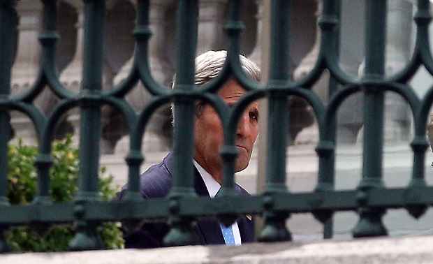 U.S. Secretary of State John Kerry walks in the garden of Coburg where closed-door nuclear talks with Iran take place in Vienna, Austria, Sunday July 12, 2015. (AP Photo/Ronald Zak)