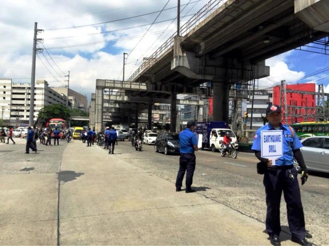Traffic along Edsa is stopped by Metropolitan Manila Development Authority personnel during the earthquake drill