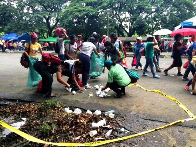 Employees of the Metro Manila Development Authority clean up after the earthquake drill