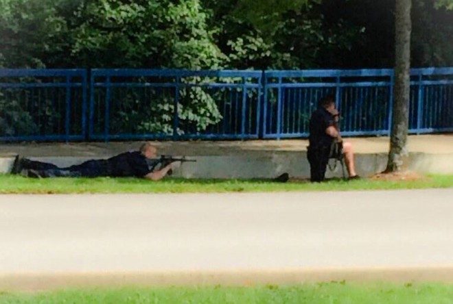 In this image made from video and released by WRCB-TV, authorities work an active shooting scene on amincola highway near the Naval Reserve Center, in Chattanooga, Tenn. on Thursday, July 16, 2015. Chattanooga Mayor Andy Berke says police are pursuing an active shooter after reports of a shooting at the military reserve center. (WRCB-TV via AP) MANDATORY CREDIT