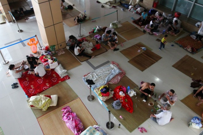 Chinese evacuees rest in a shelter facility ahead of the landfall Typhoon Chan-Hom in Leqing in eastern China's Zhejiang province Friday, July 10, 2015. Chinese authorities have evacuated tens of thousands of people, canceled scores of trains and flights and shuttered seaside resorts as a super-typhoon with wind gusts up to 200 kilometers per hour (125 mph) heads toward the southeastern coast. (Chinatopix Via AP)