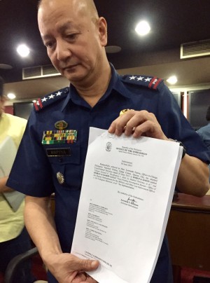 PNP OIC Deputy Dir. Gen. Leonardo Espina holds the order from the Office of the Ombudsman dismissing resigned PNP chief Director General Alan Purisima, Chief Superintendent Raul Petrasanta and nine other police officials. JULLIANE LOVE DE JESUS