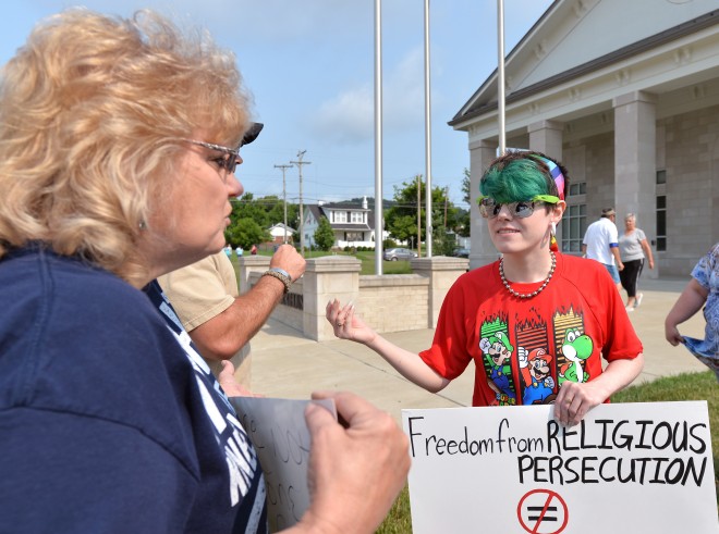 Erica Seagraves, right, has a discussion with Malinda Andrews on the steps of the Rowan County Judicial Center Tuesday, June 30, 2015, in Morehead, Ky. Rowan County Clerk Kim Davis is refusing to issue marriage licenses to all couples until further notice as an objection to the U.S. Supreme Court's ruling on same-sex marriage. The high court effectively legalized same-sex marriage in all 50 states in a 5-4 ruling Friday. (AP Photo/Timothy D. Easley)