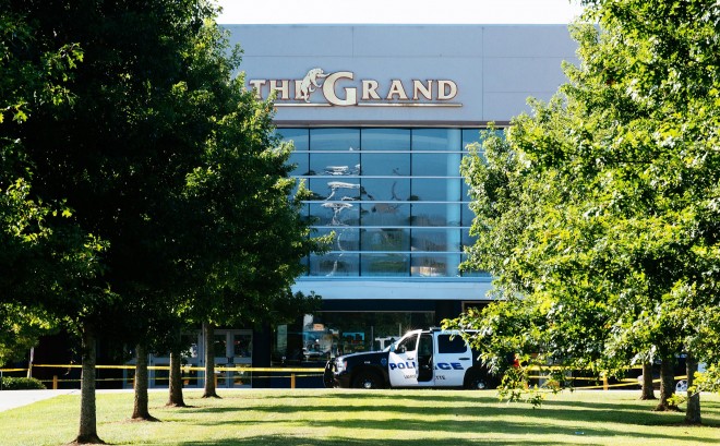 Authorities park at the scene of a Thursday night shooting at The Grand Theatre, in Lafayette, La. on Friday, July 24, 2015. John Russel Houser, 59, stood up about 20 minutes into a movie and fired first at two people sitting in front of him, then aimed his handgun at others, firing at least 13 times, police said Friday. he two fatalities were identified as 33-year-old Jillian Johnson and 21-year-old Mayci Breaux. At least one of the wounded, ranging from their late teens to their late 60s, was in critical condition, Craft said. (AP Photo/Denny Culbert)