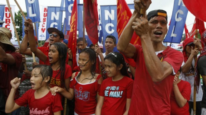 Protesters shout slogans during a rally near the House of Representatives to coincide with the last State-of-the-Nation-Address or SONA of Philippine President Benigno Aquino III at suburban Quezon city northeast of Manila, Philippines Monday, July 27, 2015. (AP Photo/Alecs Ongcal)