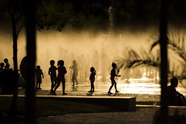 FILE - In this June 29, 2015, file photo, children play as they cool down in a fountain beside the Manzanares river in Madrid, Spain. June was warm nearly all over, with exceptional heat in Spain, Austria, parts of Asia, Australia and South America. Pakistan reported a June heat wave that killed more than 1,200 people, which according to an international database would be the 8th deadliest in the world since 1900. (AP Photo/Andres Kudacki, File)