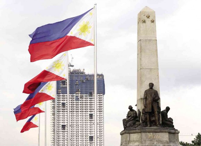 THE LOOMING Torre de Manila behind the Rizal Monument.  MARIANNE BERMUDEZ