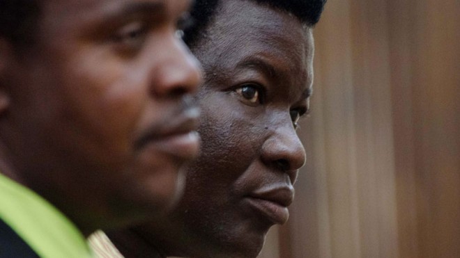 Farm owner Honest Trymore Ndlovu appears at Hwange magistrates' court to face poaching charges, about 435 miles (700 kilometers) west of the capital Harare, Wednesday, July, 29, 2015. Ndlovu and his co-defendant, professional hunter Theo Bronkhorst , are accused of helping Walter James Palmer hunt the lion. Zimbabwean police said they are looking for Palmer, the American dentist who reportedly paid $50,000 to track and kill the animal. (AP Photo)