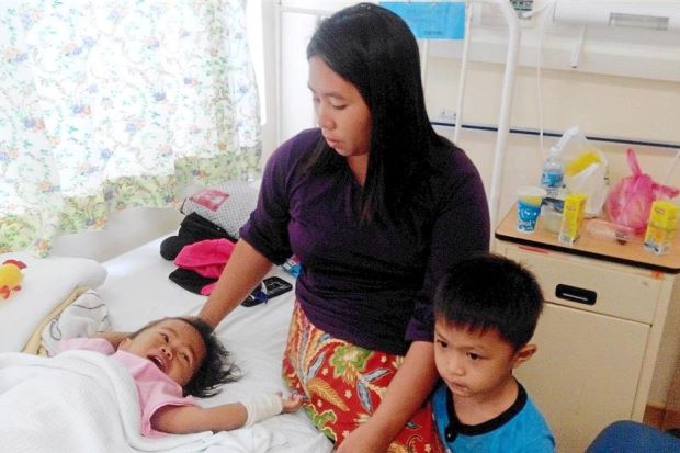 Close watch: Nurhaibah comforting Nurhasyikin at the hospital after the toddler’s terrifying ordeal.