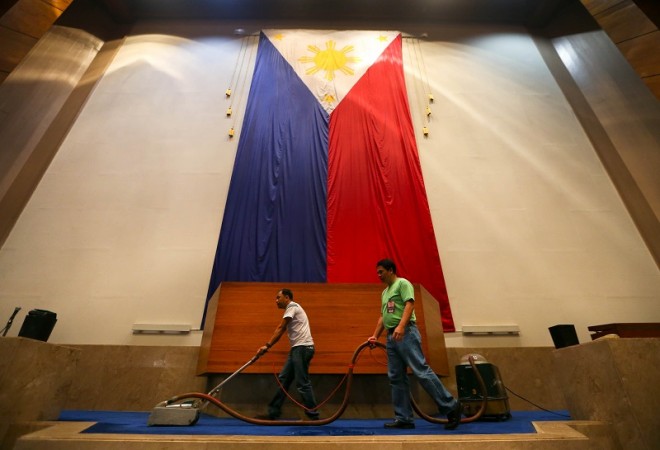 HOUSE CLEANING FOR SONA  Two men vacuum the carpet just below the podium in the Plenary Hall of the House of Representatives in preparation for the last State of the Nation Address of President Aquino on Monday, July 27. LYN RILLON