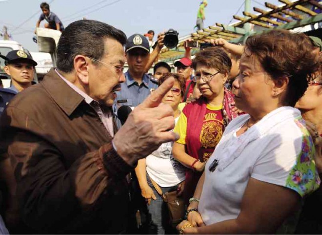 GUESS WHO WENT TO THE MARKET? Manila Mayor Joseph Estrada tries to convince Quinta market vendors of the benefits of its modernization. RAFFY LERMA
