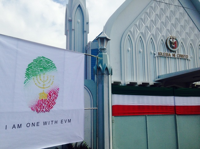 Tapaulins that read "One with EVM" were hang outside the church of the Iglesia ni Cristo in Los Baños Laguna. The number of attendees and cars parked outside the church was unusually big on Sunday,a day before the INC's 101st anniversary. MARICAR CINCO/PHILIPPINE DAILY INQUIRER