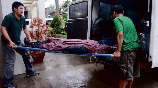 CRASH FATALITY Funeral parlor workers bring the body of Felicisimo Taborlupa Jr., pilot of the helicopter that crashed on Mount Maculot in Cuenca, Batangas province, to MartinMarasigan Memorial Hospital in Cuenca. ARNOLD ALMACEN
