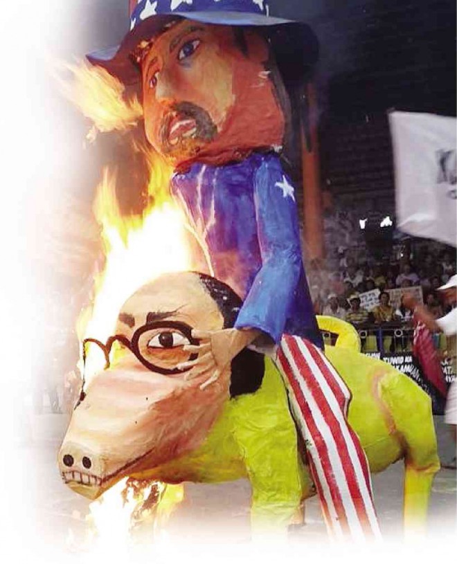 PROTESTERS in Iloilo City burn an effigy showing Uncle Sam riding a yellow horse with a likeness to President Aquino, who, in his last State of the Nation Address on  July 27, described protesters and critics with no concrete proposals or alternatives to government programs as useless noisemakers. NESTOR P. BURGOS JR./INQUIRER VISAYAS 