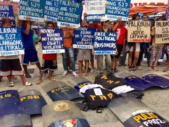 Militants return to the PNP shields, protective gear and cellphones of anti-riot cops they encountered on Monday. Julliane Love De Jesus/INQUIRER.net