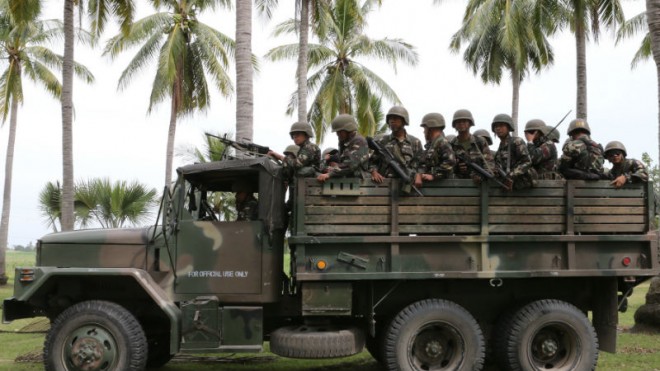 In this Feb. 25, 2015, photo, soldiers on board a military truck are seen in Pikit, North Cotabato, on an “all-out offensive operation” against the Bangsamoro Islamic Freedom Fighters. The Department of National Defense (DND) on Tuesday said there was nothing irregular in its decision to shelve the planned acquisition of the P6.5-billion missile system from Israel for the Philippine Army in view of the country’s internal security threats.  PHOTO BY JEOFFREY MAITEM/INQUIRER MINDANAO