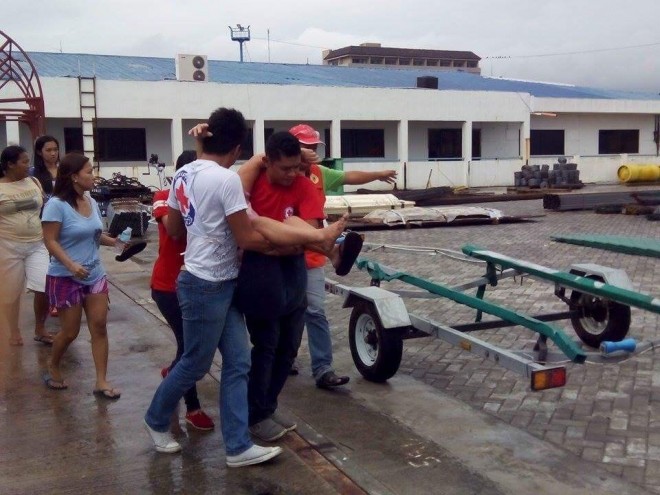 Rescuers carry female passengers of ill-fated MB Nirvana in Ormoc City, Leyte to a waiting ambulance so she can be brought to the hospital after she developed seizure. 