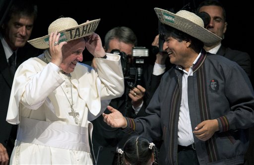 Pope Francis and Bolivia's President Evo Morales, smile as they don the traditional Bolivian hats they were given at the second World Meeting of Popular Movements in Santa Cruz, Bolivia, Thursday, July 9, 2015. Francis gave a late-afternoon speech to delegates at the gathering. AP