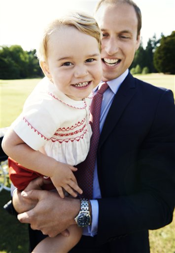 In this handout image released by Kensington Palace on Tuesday July 21, 2015, Britain's Prince William holds his son Prince George following the christening of Princess Charlotte, in the grounds of Sandringham House, England, Sunday, July 5, 2015. The photo has been released in time for Prince George's second birthday on Wednesday, July 23, 2015. (Mario Testino/Art Partner/Kensington Palace via AP)   