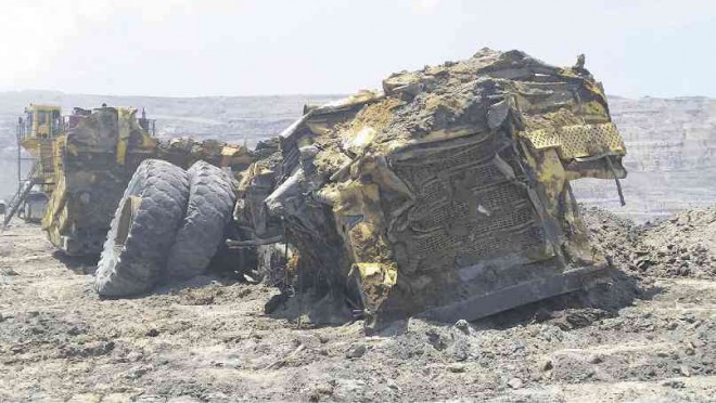 ONE OF THE HEAVY trucks used in mining operations on Semirara Island in Caluya, Antique province, lies crumpled when a wall of the Panian open pit collapsed last week. NESTOR P. BURGOS JR. / INQUIRER VISAYAS