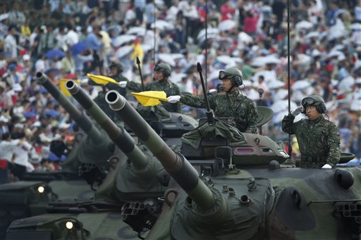 Taiwan's military displays tanks in front of thousands of spectators in a parade marking the 70th anniversary of the end of WWII, at the military base in Hsinchu, northern Taiwan, Saturday, July 4, 2015. Taiwan marched out thousands of troops and displayed its most modern military hardware Saturday to spotlight an old but often forgotten claim that its forces, not the Chinese Communists, led the campaign that routed imperial Japan from China 70 years ago. AP PHOTO
