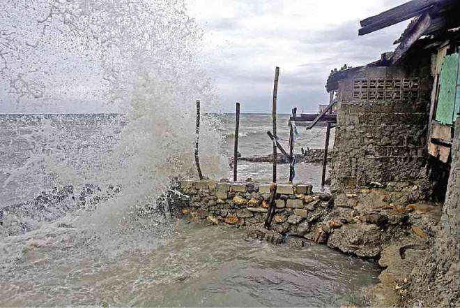 WAVES destroy houses made of light materials in coastal areas in Talisay City, Cebu. LITO TECSON/CEBU DAILY NEWS