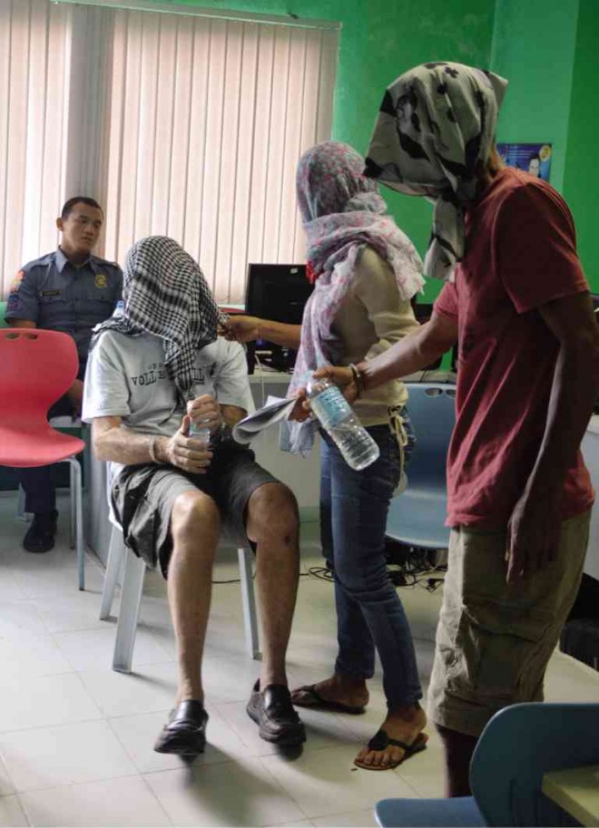 AN AMERICAN human trafficking suspect covers himself as his victims are presented to authorities in the office of the Cebu vice governor. The war on trafficking, however, should go beyond mere arrests, said Davao City Mayor Rodrigo Duterte. CHRISTIAN MANINGO/CEBU DAILY NEWS 