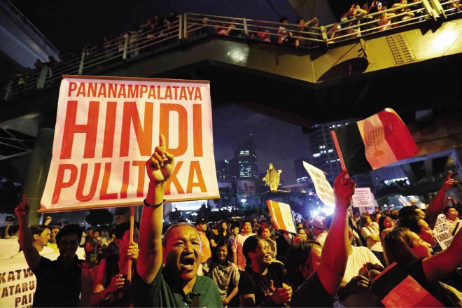 ‘FAITH, NOT POLITICS’  So goes the message on a placard hoisted by members of the Iglesia ni Cristo (INC), which moved its forces to the Catholics’ hallowed Edsa Shrine in Quezon City on Friday night after a mass action that began the previous day at the Department of Justice (DOJ) in Manila. The religious group wants the DOJ to stop its investigation of a criminal complaint filed by an expelled minister against INC advisory council members. LYN RILLON