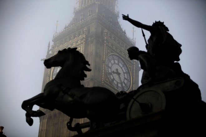 FILE - In this Thursday, March 15, 2012 file photo, the Boudica statue stands in the foreground as fog shrouds the clock tower which houses the Big Ben bell at the Palace of Westminster, London. Officials on Tuesday, Aug. 25, 2015 said that the famous clock at Britain's Parliament, used by people across Britain to check the time, has recently been slow by as much as six seconds. (AP Photo/Matt Dunham, File)