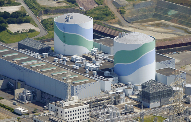 This aerial photo shows reactors of No. 1, right, and No. 2, left,  at the Sendai Nuclear Power Station in Satsumasendai, Kagoshima prefecture, southern Japan, Tuesday, Aug. 11, 2015.  Kyushu Electric Power Co. said Tuesday, Aug. 11, 2015,  it had restarted the No. 1 reactor at its Sendai nuclear plant as planned. The restart marks Japan's return to nuclear energy four-and-half-years after the 2011 meltdowns at the Fukushima Dai-ichi nuclear power plant in northeastern Japan following an earthquake and tsunami.(Kyodo News via AP) JAPAN OUT, MANDATORY CREDIT