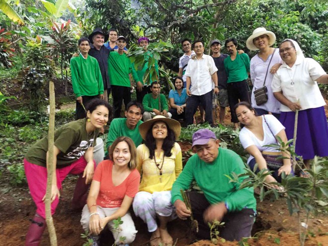 STARTING SUSTAINABLE FARMS     Several participants from the Green Unconference held in Makati last week plant their first cacao tree at Kai Farm in Silang, Cavite, after learning permaculture—or building self-sustaining agrisystems—from permaculture design consultant Mark Garrett (standing, second from left, in black hat).  The group includes Unconference conveners Karla Delgado (standing, left) and Amena Bal (in yellow), and Sister Nelda from Bukidnon (standing, right), who is bringing permaculture to communities in Mindanao. CONTRIBUTED PHOTO