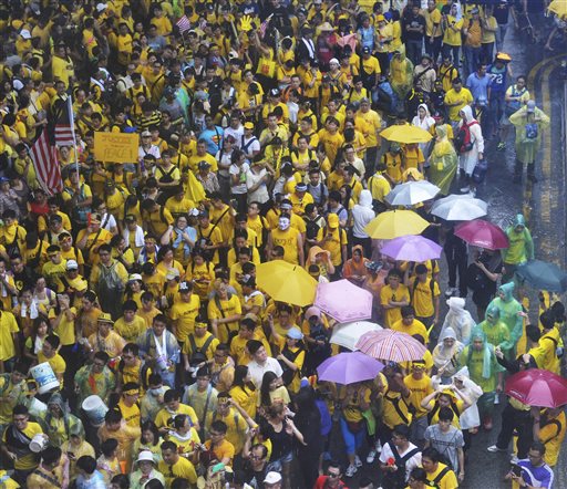 Malaysian protesters gather in the rain during a rally in Kuala Lumpur, Malaysia on Sunday, Aug. 30, 2015. Big crowds of protesters returned to the streets of Kuala Lumpur on Sunday to demand the resignation of Malaysian Prime Minister Najib Razak over a financial scandal, after the first day of the massive rally passed peacefully. (AP Photo)