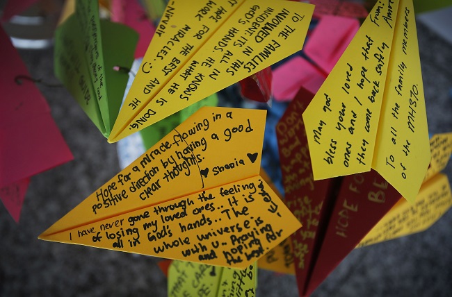FILE - In this March 15, 2014, photo, paper planes with personalized messages dedicated to people involved with the missing Malaysia Airlines jetliner MH370, are placed at the viewing gallery of Kuala Lumpur International Airport, in Sepang, Malaysia. Part of the mystery of what happened to a Malaysia Airlines plane that vanished last year may be solved with air safety investigators confident that debris found in the Indian Ocean is a wing part unique to the Boeing 777, the same model as the missing jet, a U.S. official said Wednesday, July 29, 2015. Air safety investigators  one of them a Boeing investigator have identified the component that was found on the French island of Reunion in the western Indian Ocean as a "flaperon" from the trailing edge of a 777 wing, the U.S. official said. (AP Photo/Wong Maye-E)