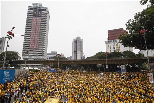 Activists from the Coalition for Clean and Fair Elections (BERSIH) gather on a main road in downtown Kuala Lumpur, Malaysia, during a rally Sunday, Aug. 30, 2015. Big crowds of protesters returned to the streets of Kuala Lumpur on Sunday to demand the resignation of Malaysian Prime Minister Najib Razak over a financial scandal, after the first day of the massive rally passed peacefully. (AP Photo/Joshua Paul)