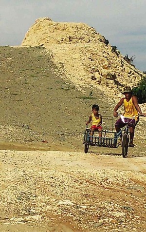A FATHER and his son pass through an unfinished road that is part of a shelved airport development project in Alaminos City in Pangasinan.  YOLANDA SOTELO