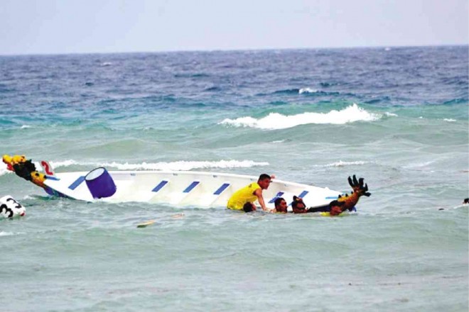 ROUGH seas caused one of the dragon boats to capsize during the 1st Panglao Dragon Boat Challenge  in Bohol province. PHOTOS BY Ric V. Obedencio