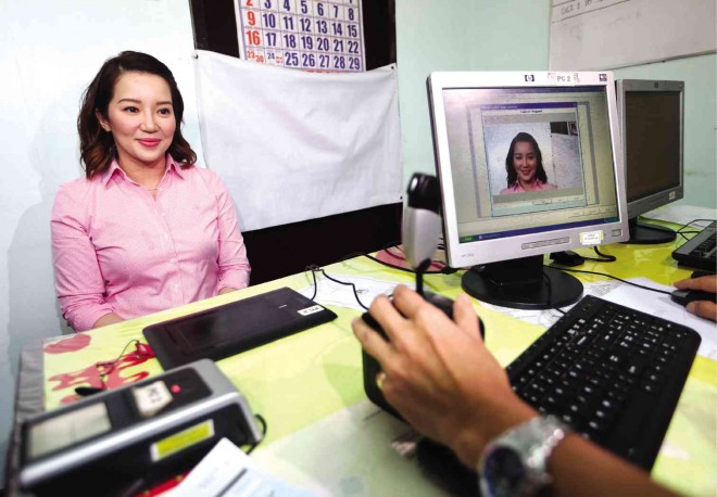 BIOMETRICS  President Aquino’s sister Kris Aquino undergoes the biometrics process  at the Commission on Elections office in Quezon City so they can vote next year.  LYN RILLON