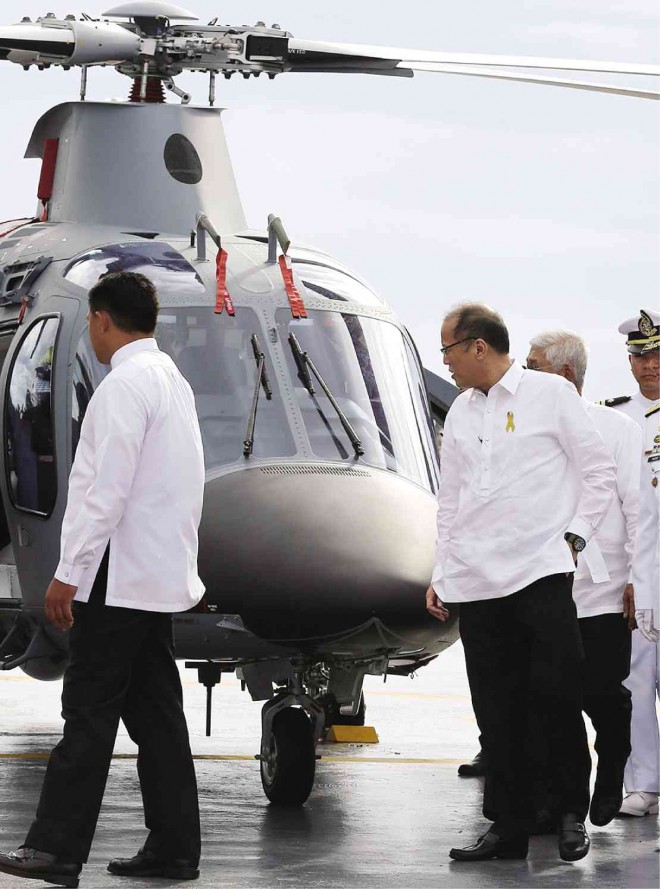 PRESIDENT Aquino takes a close look at a new helicopter for the Philippine Navy, one of the armed forces branches that his administration is trying to strengthen amid ongoing Chinese aggression in the West Philippine Sea, which is also prompting the reuse of Subic as a military base. MARIANNE BERMUDEZ 