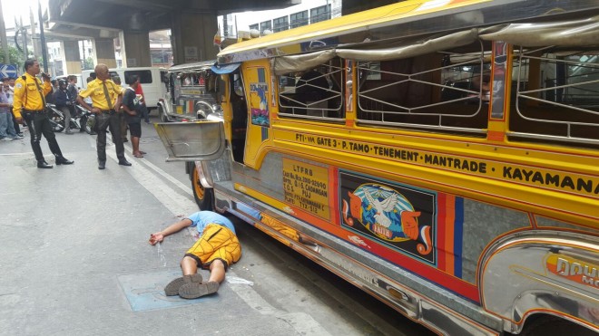 Jeepney driver Jerric Accad lies on the pavement after being shot by an irate pedestrian in Makati City. INQUIRER.net FILE PHOTO/CENON BIBE JR.