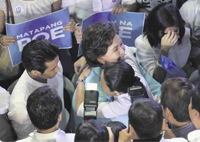 EMOTIONAL RUSH  After declaring her intention to seek the 2016 presidency in her speech on Wednesday at Ang Bahay ng Alumni, UP Diliman, Sen. Grace Poe hugs her mother, Susan Roces, in a moving, mothering moment, while son Brian (left) looks on.  LYN RILLON