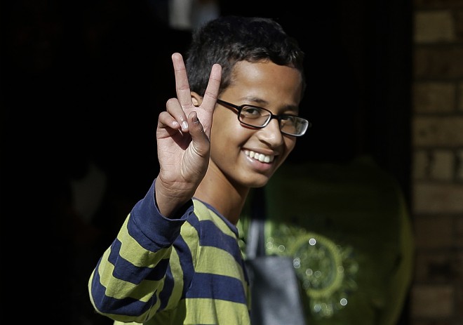 Ahmed Mohamed, 14, gestures as he arrives to his family's home in Irving, Texas, Thursday, Sept. 17, 2015. Ahmed was arrested Monday at his school after a teacher thought a homemade clock he built was a bomb. He remains suspended and said he will not return to classes at MacArthur High School. (AP Photo/LM Otero)