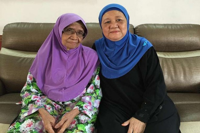 Madam Amedah Osman (right) with her adoptive mother, Madam Ruminah Jaafar.ST PHOTOS: LIM YI HAN