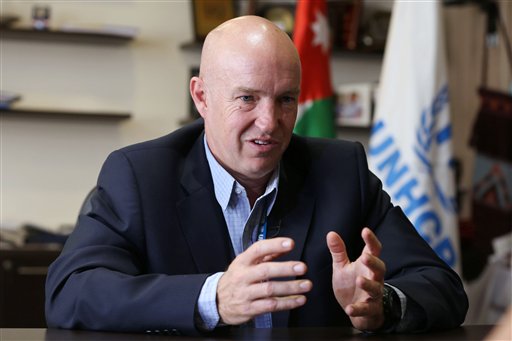 In this Wednesday, Sept. 9, 2015, photo, the head of the U.N. refugee agency in Jordan, Andrew Harper, speaks during an interview with The Associated Press in Amman, Jordan. The influx of refugees to Europe was triggered in part by donors taking the "cheap option" and not giving enough aid to displaced Syrians in Middle Eastern asylum countries, Harper said in an interview. (AP Photo/Raad Adayleh)