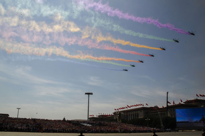 Military aircraft fly in formation during a military parade to commemorate the 70th anniversary of the end of World War II, in Beijing Thursday, Sept. 3, 2015. (Rolex Dela Pena/Pool Photo via AP)
